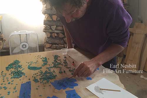 Earl placing turquoise in voids of cluster maple burl slab